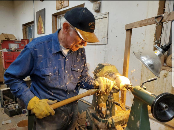 Bob Epsen, master wood turner turning wood in a shop
