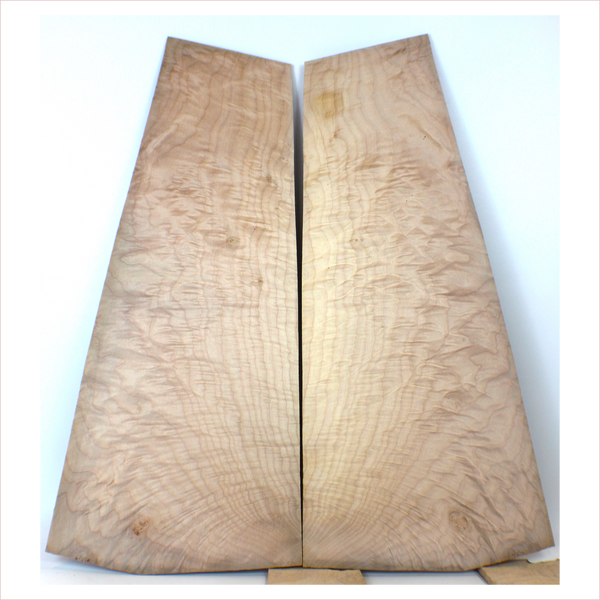 Interesting quilted maple book match with flat-sawn flame figure on the edges.  3A grade figuring and little burls.  This set has been sanded to 400 grit.  Dimensions: Thickness (each piece): .25", Max width: 9.75", Length: 22".